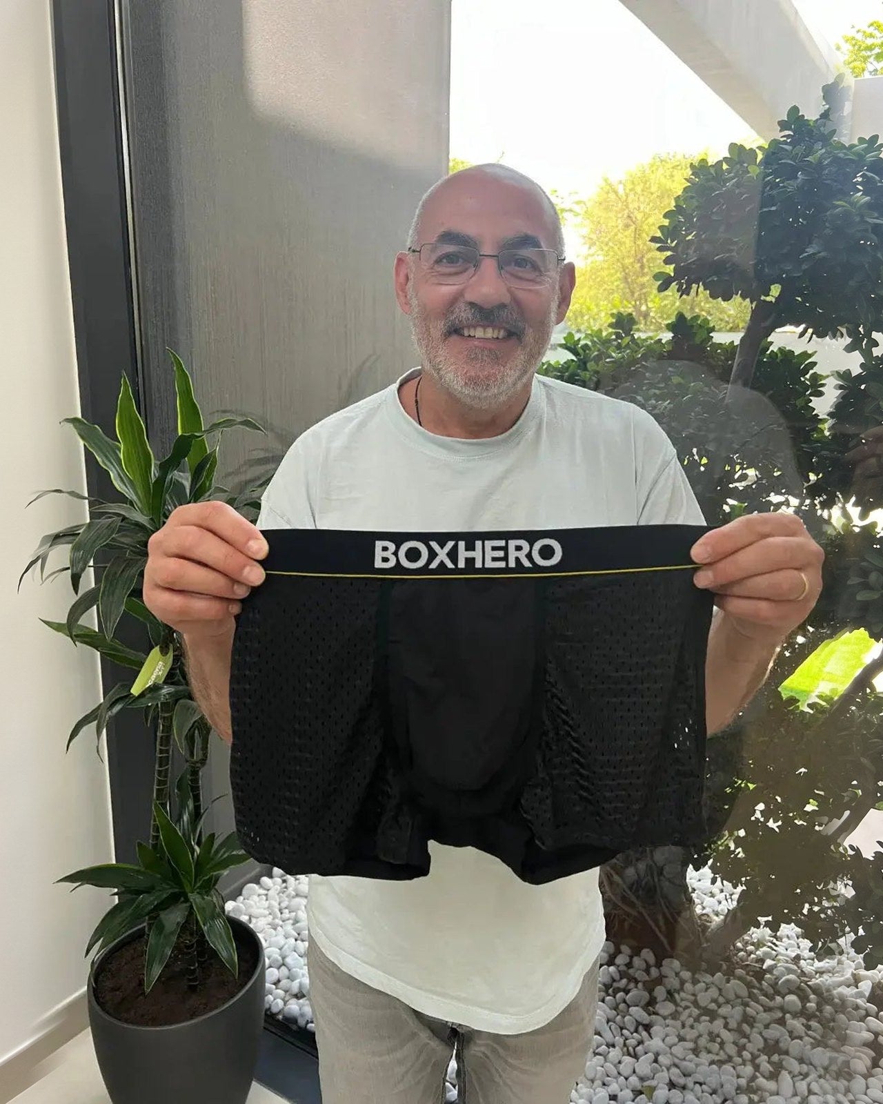 A BoxHero customer holding up his BoxHero 2.0