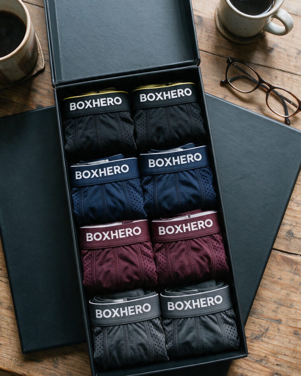 The BoxHero 8-pack open on the kitchen table: black, blue, red and grey