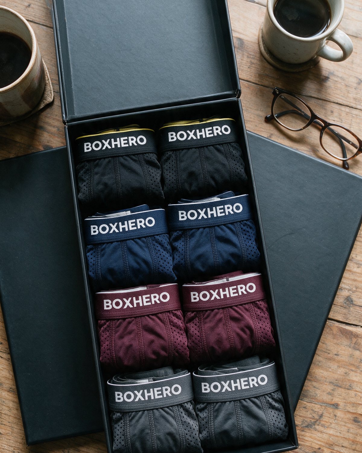 The BoxHero 8-pack open on a table: black, blue, red and grey